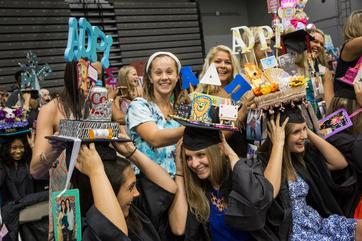 Students at convocation with their caps decorated