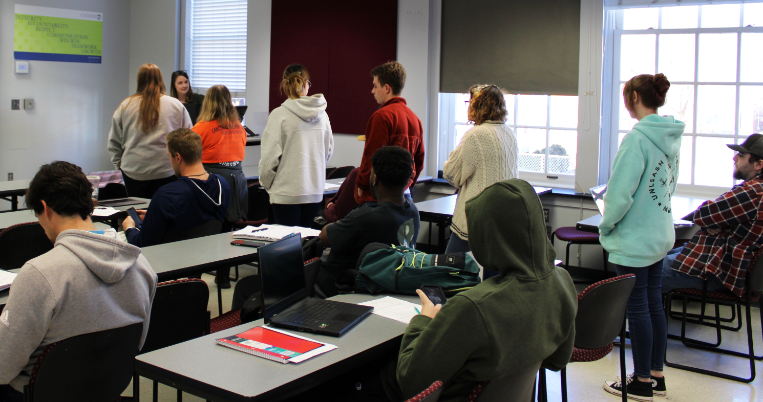 Students wait in line to participate in an experiment.