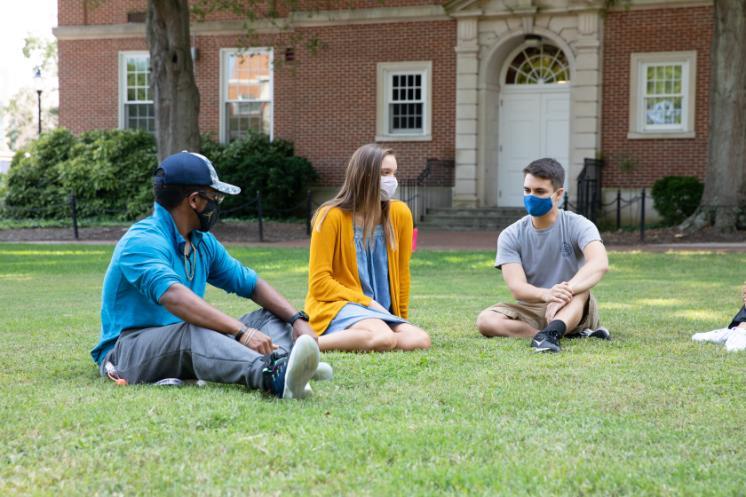 students sit outside stevens hall