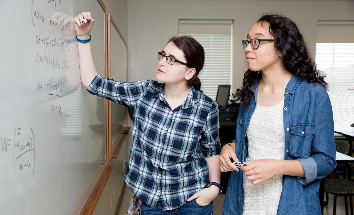 Nicole Marzolf ’18 (left) and Breana Figueroa ’19 (right) tackle Lorentzian geometry as part of their summer research project