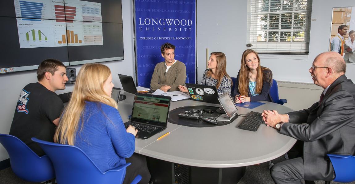 Students in a business school classroom with a professor