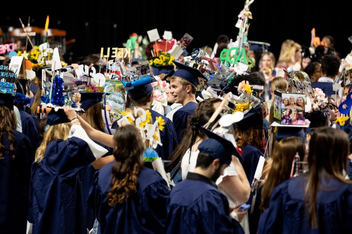 Student in the midst of the sea of caps at Convocation 2024